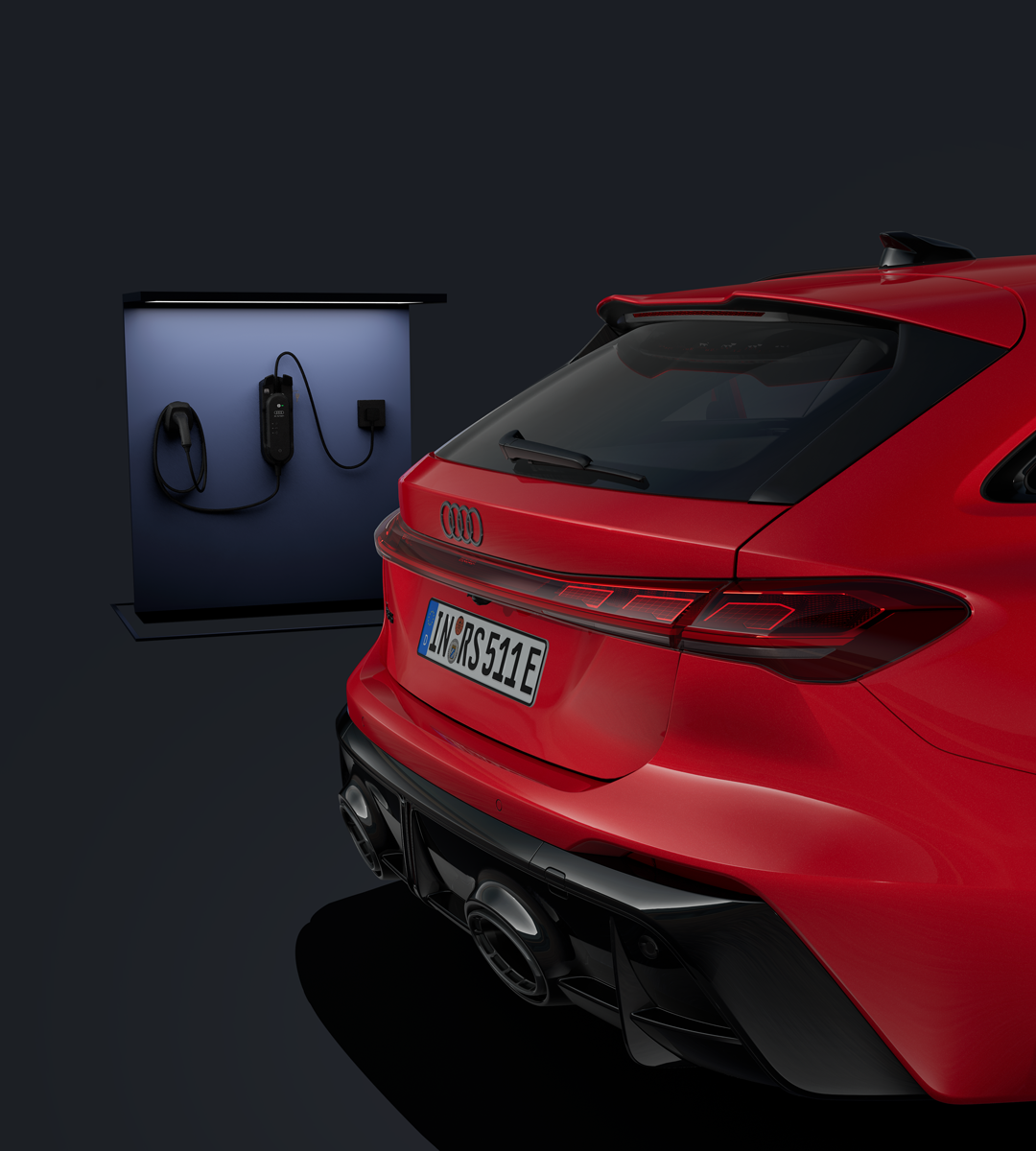 Die Rückseite eines roten Audi RS 5 Avant in einer dunklen Umgebung ist zu sehen. 